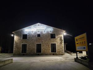 a brick building with a sign on the side of it at El Mensario in Campisábalos