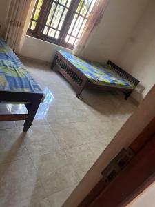 a living room with a couch and a table at Dissanayaka house in Nikawatawana