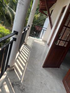 a porch of a house with a wooden door at Dissanayaka house in Nikawatawana +3 photos