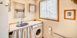 a bathroom with a washing machine and a sink at VE361-Vejers-Strand-Violvej-4 in Vejers Strand +13 photos