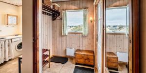 a laundry room with a washer and dryer and windows at VE361-Vejers-Strand-Violvej-4 in Vejers Strand