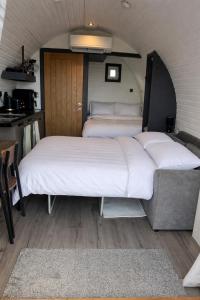 a bedroom with two beds in a room at Millfield Glamping Pods - Heatherhouse in Orkney