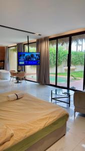 a bedroom with a large bed and a flat screen tv at مجموعة سدرة فاطمة in Al Ahsa +162 photos