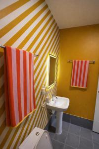 a bathroom with a sink and a white toilet at CenterPoint Thong Sala in Thong Sala +36 photos