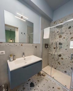 a bathroom with a sink and a shower at WelcHome Vitorchiano Guest House in Vitorchiano +37 photos