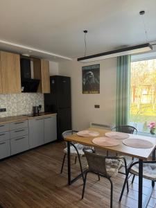 a kitchen and dining room with a table and chairs at Хрю-хрю in Brovary