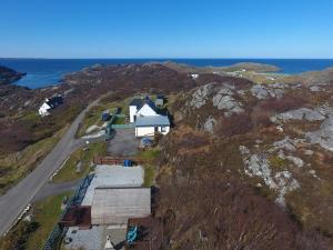 an aerial view of a house on the side of a mountain at Selkie Cabin Achmelvich, Lochinver in Lochinver
