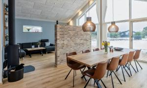 a dining room with a wooden table and chairs at VE250-Vejers-Strand-Engesovej-56 in Vejers Strand