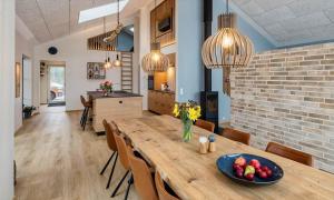 a dining room and kitchen with a wooden table and chairs at VE250-Vejers-Strand-Engesovej-56 in Vejers Strand