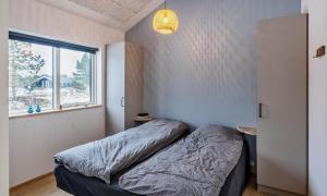 a small bedroom with a bed and a window at VE250-Vejers-Strand-Engesovej-56 in Vejers Strand +25 photos
