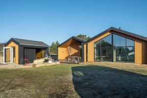 a house with a large window and a yard at VE250-Vejers-Strand-Engesovej-56 in Vejers Strand