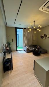 a large living room with a bed and a wooden floor at مجموعة سدرة فاطمة in Al Ahsa