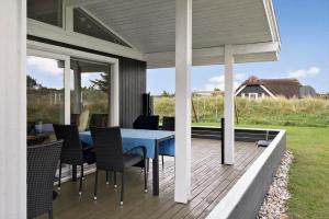 a patio with a blue table and chairs at VE494-Orbaek-Jafdalvej-51 in Ørbæk
