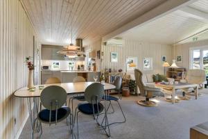 a kitchen and living room with a table and chairs at VE494-Orbaek-Jafdalvej-51 in Ørbæk