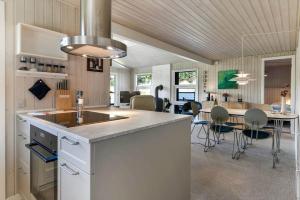 a kitchen and dining room with a table and chairs at VE494-Orbaek-Jafdalvej-51 in Ørbæk +19 photos