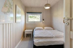 a small bedroom with a bed and a window at VE494-Orbaek-Jafdalvej-51 in Ørbæk