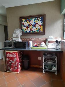 a counter in a kitchen with a cocacola counter sidx sidx sidx at Stadion Sleepover Cabin in Sasolburg