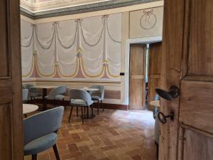 a dining room with tables and chairs and a curtain at Palazzo Brunamonti Boutique Hotel in Bevagna +81 photos