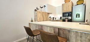 a kitchen with a counter with chairs and a counter top at Tropical - Resort - Spa - Pool & Garden in Grand-Baie