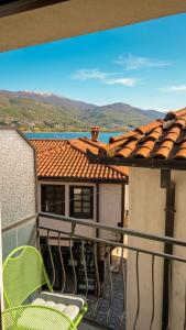 a balcony with chairs and a view of a house at Apartmani Marija in Ohrid