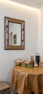 a mirror on a wall above a table with a table sidx sidx at Apartmani Marija in Ohrid