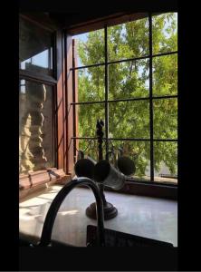 a kitchen window with a view of a tree at Dreamy Cottage in Ayiá