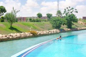 a person swimming in a pool in a river at Amer group in El Alamein