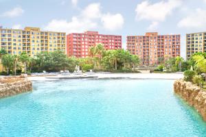 a river in front of buildings and a beach at Amer group in El Alamein