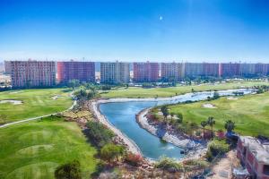an aerial view of a golf course and a river at Amer group in El Alamein +8 photos