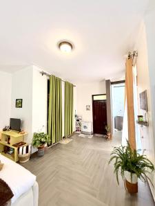a living room with potted plants on the floor at The Reset Stay in Kampala