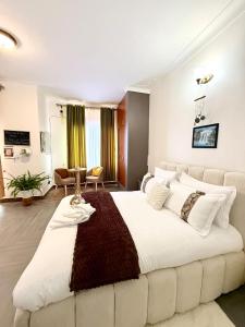 a large white bedroom with a large white bed at The Reset Stay in Kampala