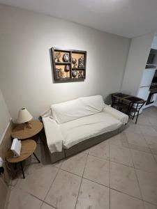 a bedroom with a bed and two tables and a mirror at Nice apartment close to the sea in Athens