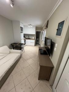 a living room with a bed and a kitchen at Nice apartment close to the sea in Athens