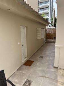 an empty hallway of a building with a white door at Nice apartment close to the sea in Athens