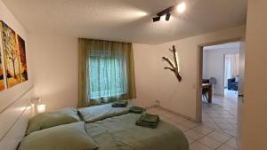a living room with a couch and a window at Ferienwohnung Waldblick in Allensbach