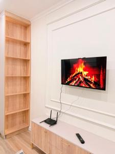 a living room with a tv on a wall at Ulytau in Almaty