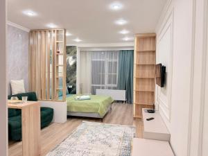 a hotel room with a bed and a television at Ulytau in Almaty