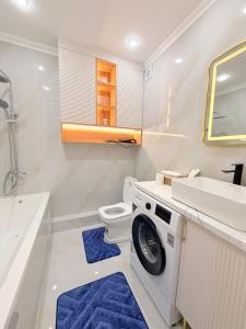 a bathroom with a sink and a washing machine at Ulytau in Almaty