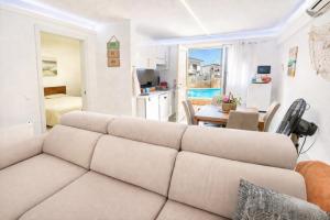 a living room with a couch and a table at VIP private Poolsuite Calafell in Calafell