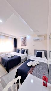a bedroom with two beds and a table at PRETTY HOUSE in Pamukkale