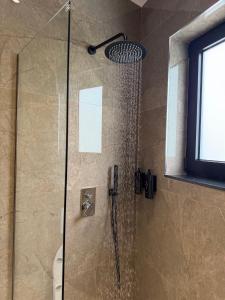a shower in a bathroom with a glass shower backdoor at Hotel Kloi - Rooms & Jacuzzi Vlore in Vlorë +25 photos
