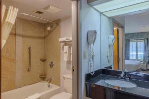 a bathroom with a sink and a toilet and a phone at Townhouse Fort Walton Beach Hurlburt Field in Mary Esther +26 photos