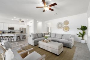 a living room with a couch and a ceiling fan at Gorgeous Lakefront Paradise w Pool & Views in Chandler