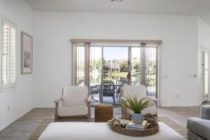 a living room with a couch and chairs and a table at Gorgeous Lakefront Paradise w Pool & Views in Chandler +25 photos