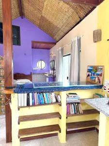 a room with a counter filled with books at Loft com vista Panoramica in Paraty