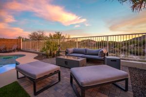 a patio with a couch and chairs and a pool at Heated Pool 3BR Retreat Estrella Mountain in Goodyear