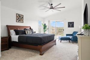 a bedroom with a bed and a ceiling fan at Heated Pool 3BR Retreat Estrella Mountain in Goodyear