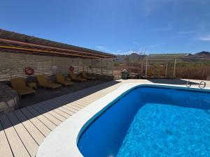 a swimming pool on a deck next to a house at Terlingua Ranch Lodge in Terlingua