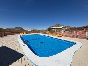 a large swimming pool on a wooden deck with chairs at Terlingua Ranch Lodge in Terlingua +50 photos
