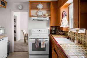 a kitchen with a stove and a sink at Charming 2-BR Farmhouse Backyard Views in Mesa +20 photos